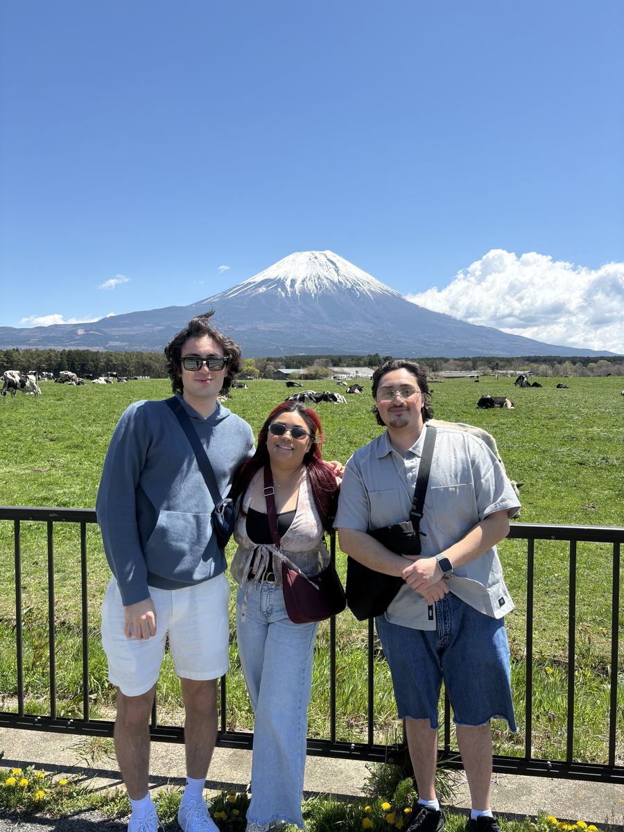 Couple at the plateau with cows and Mt. Fuji