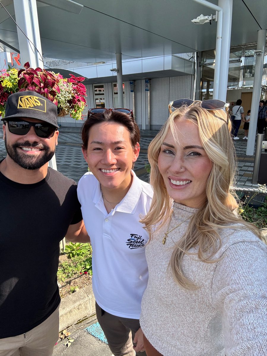 Guests and their guide smiling outside Shin-Fuji Station