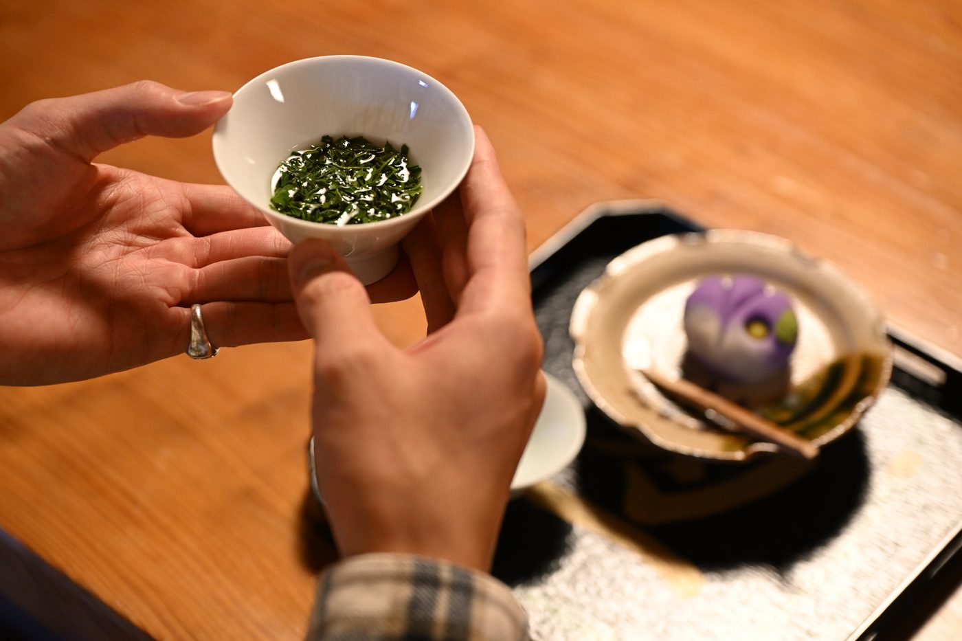 A small cup of freshly brewed sencha green tea served on a tray