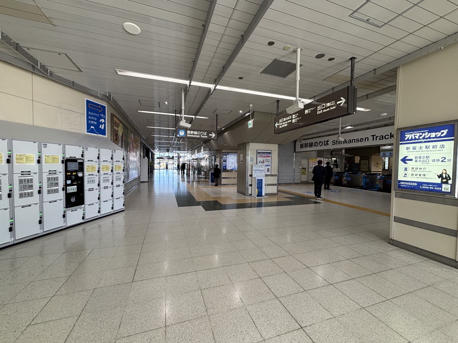 Shin-Fuji Station concourse with a row of coin lockers on the left and the Shinkansen ticket gates ahead